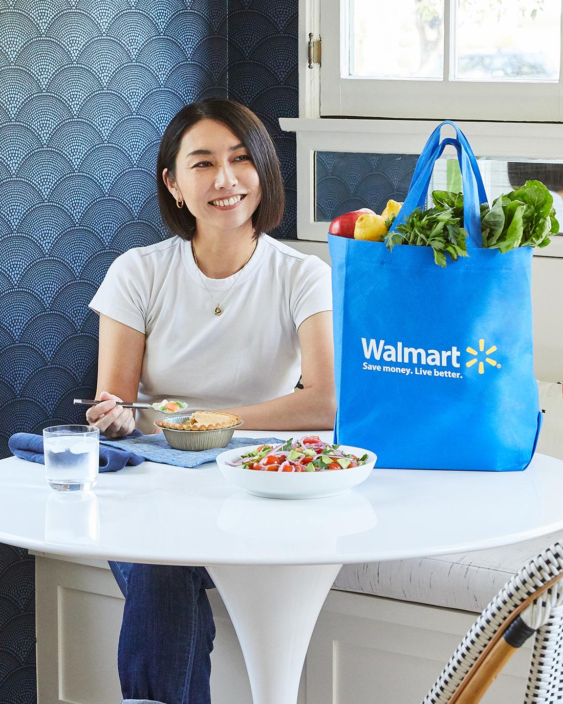 Rie posed with finished meal and Walmart bag