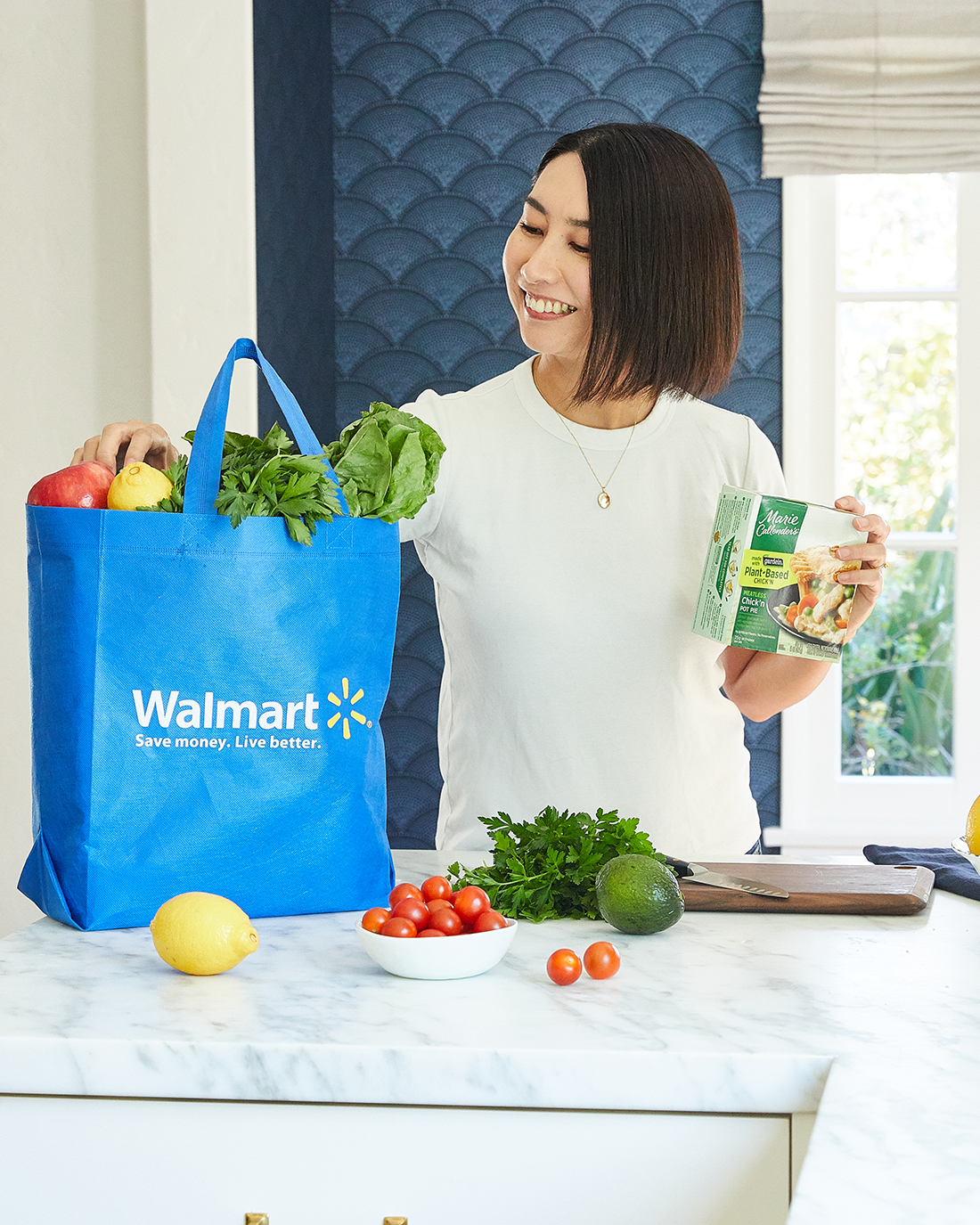 Rie posing with the bag of Walmart grocery ingredients for the meal