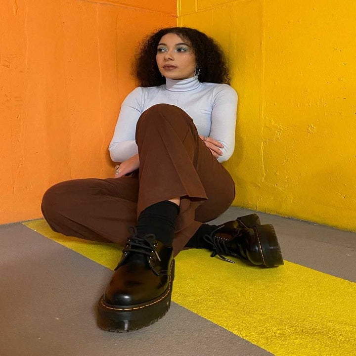 A model posing in the black platform shoes
