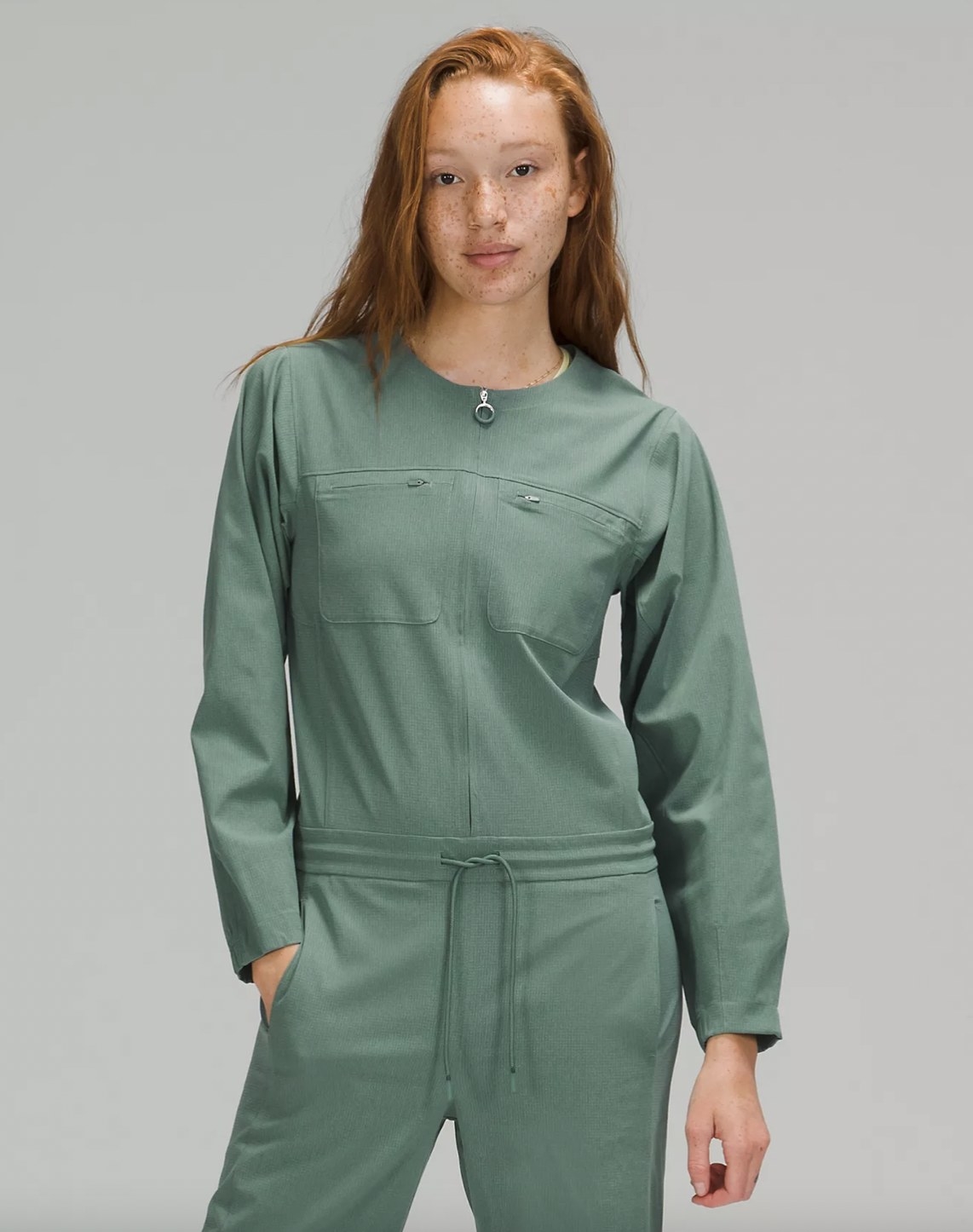 A woman wearing a green jumpsuit