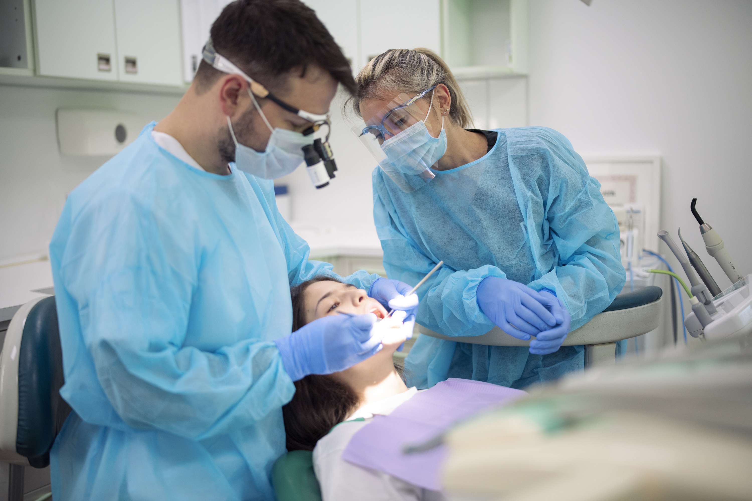 Dentist and assistant working on a patient