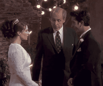 Ross is kissing a bride at the altar while she looks angry