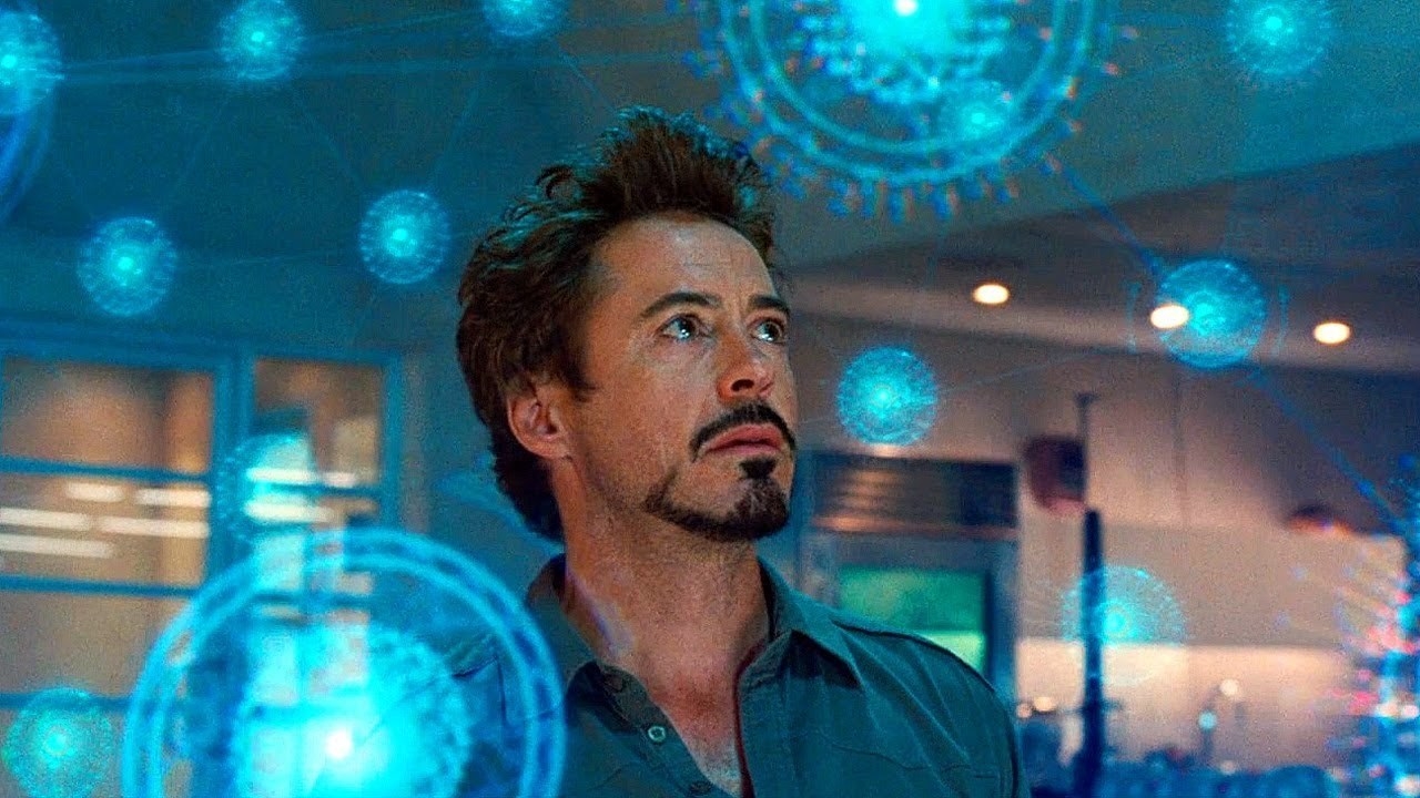 Tony Stark looks around at different hologram diagrams