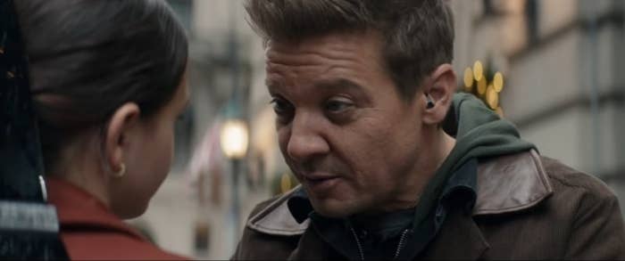 A close up of Hawkeye as he talks to his daughter