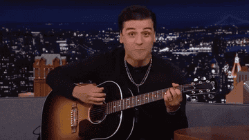 GIF of Oscar playing the guitar and Jimmy clapping