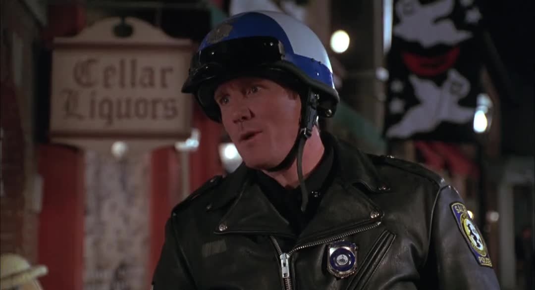 Man dressed as a cop and wearing a motorcycle cop helmet