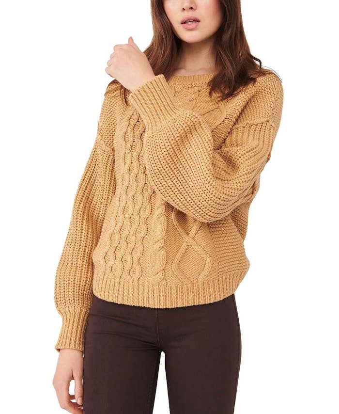 model wearing cable knit sweater