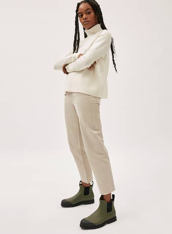 A model wearing the olive colored boots