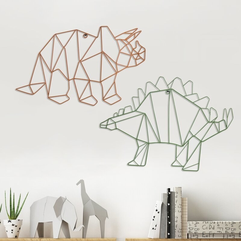 a triceratops and a stegosaurus sculpture hanging on the wall