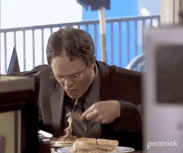 Dwight Schrute eating a huge stack of pancakes.