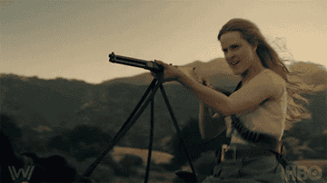 Dolores from &quot;Westworld&quot; horseback riding with a gun.