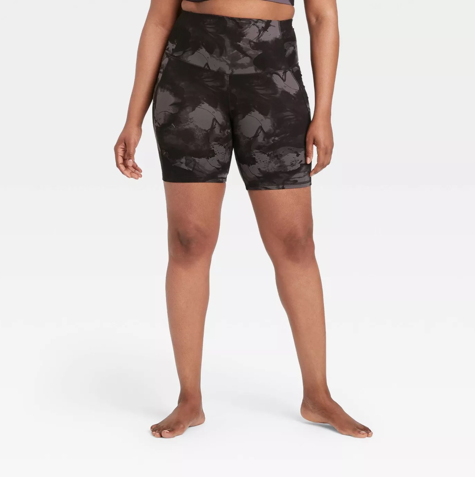 Model wearing the bike shorts in black and gray acid wash