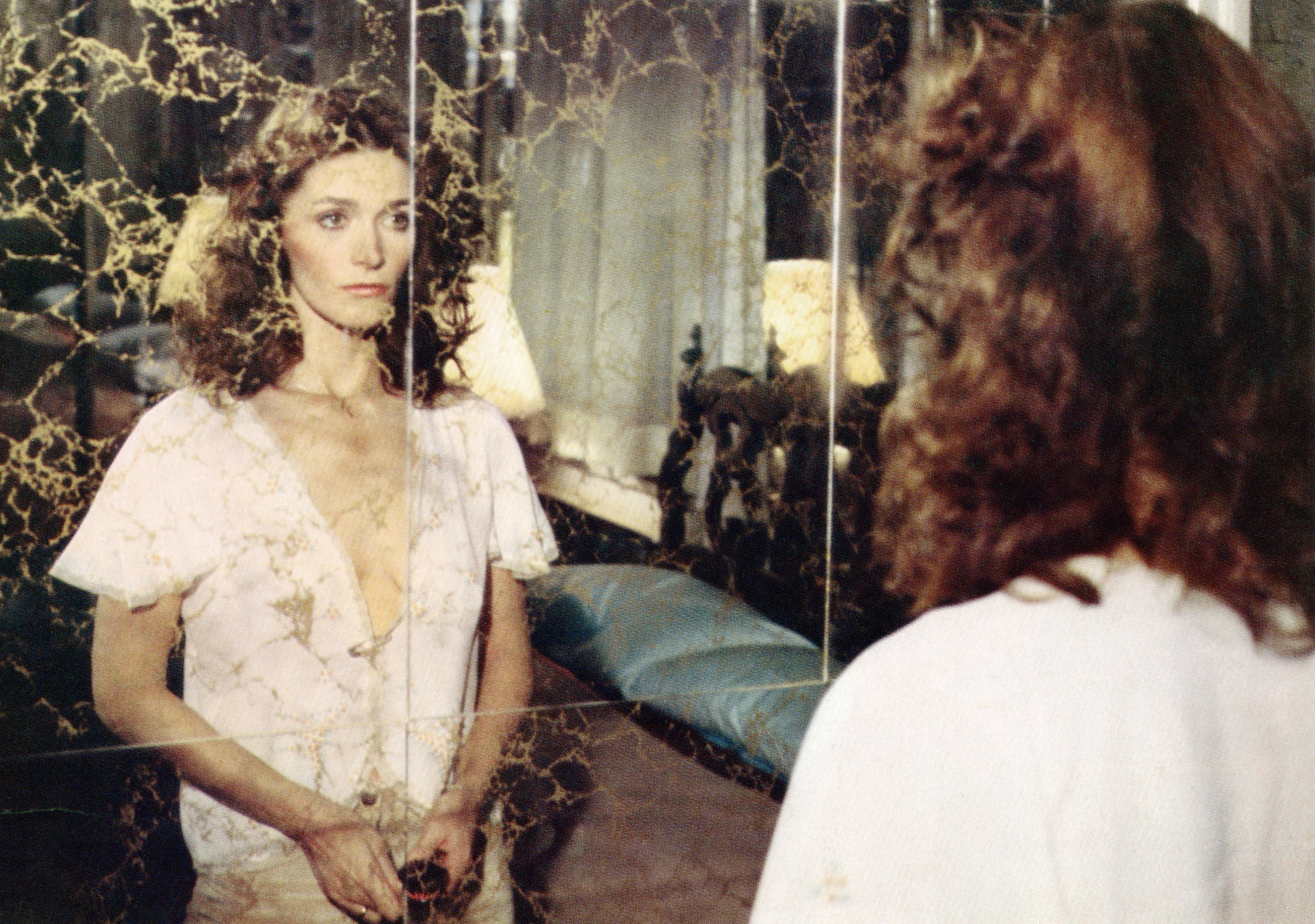 Margot Kidder looks into a mirror