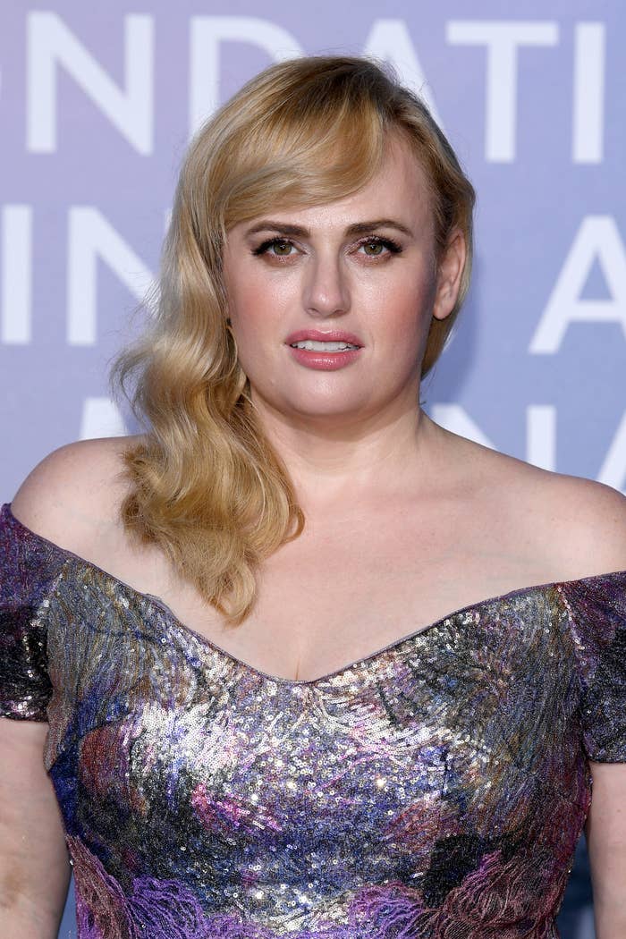 Blonde Rebel Wilson in a off the the shoulder sparkling gown