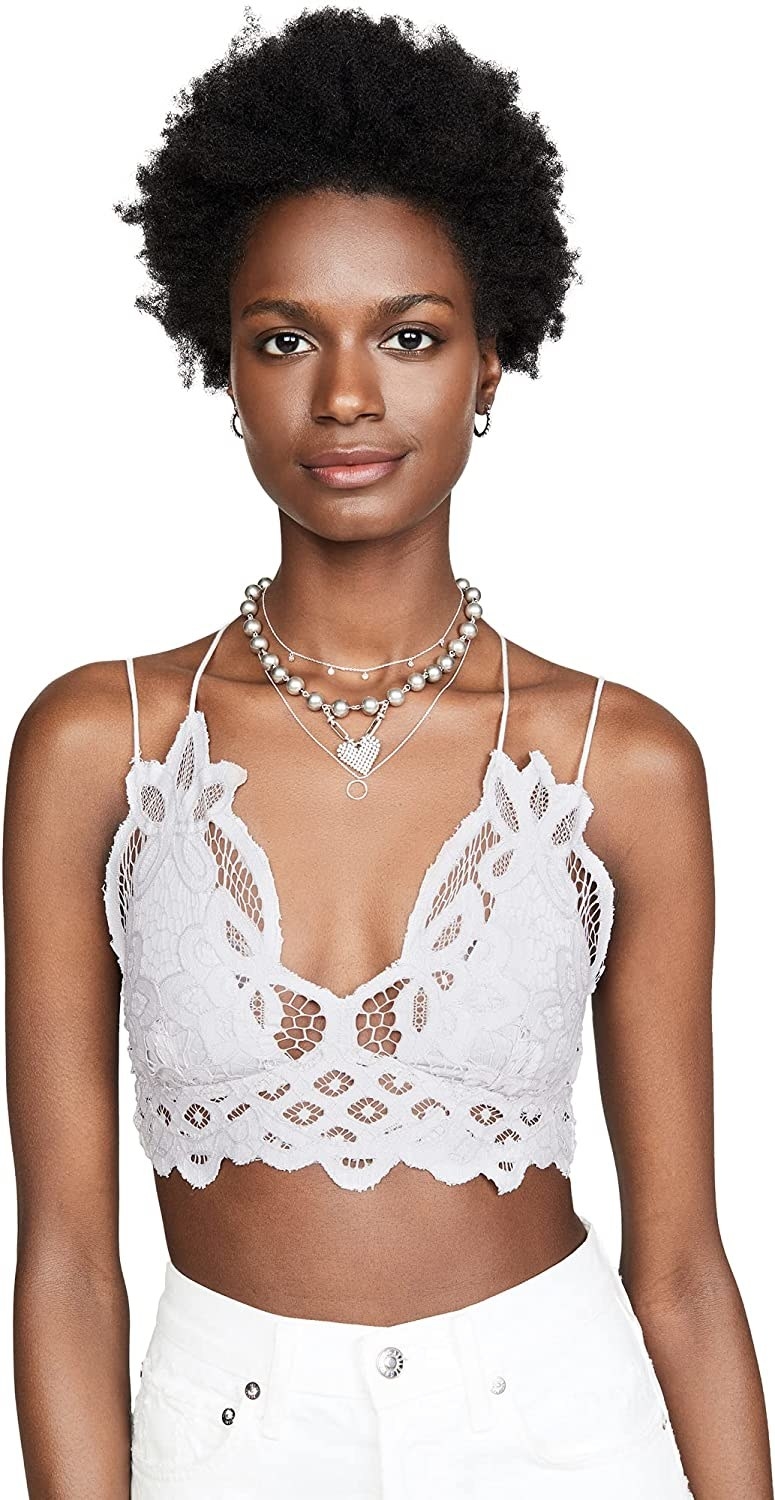 Model wearing white lace bralette