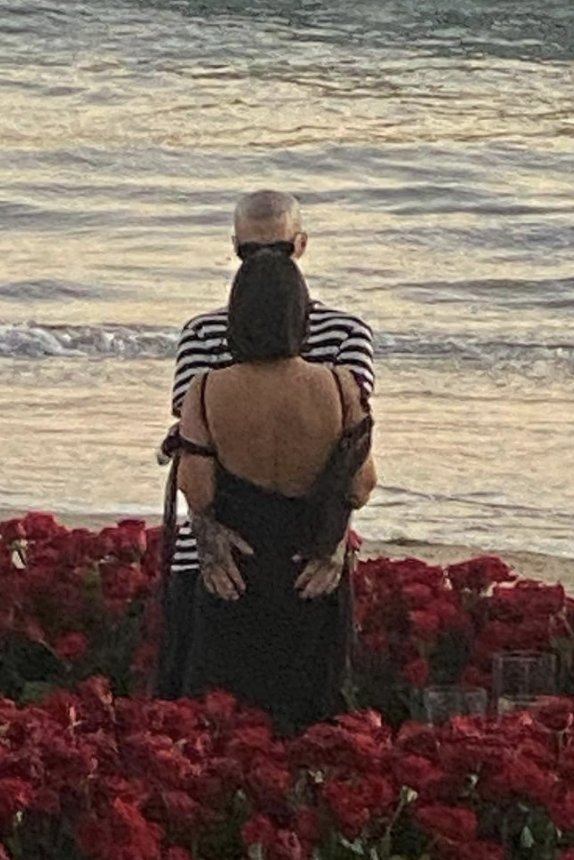 Kourtney and Travis embracing on the beach