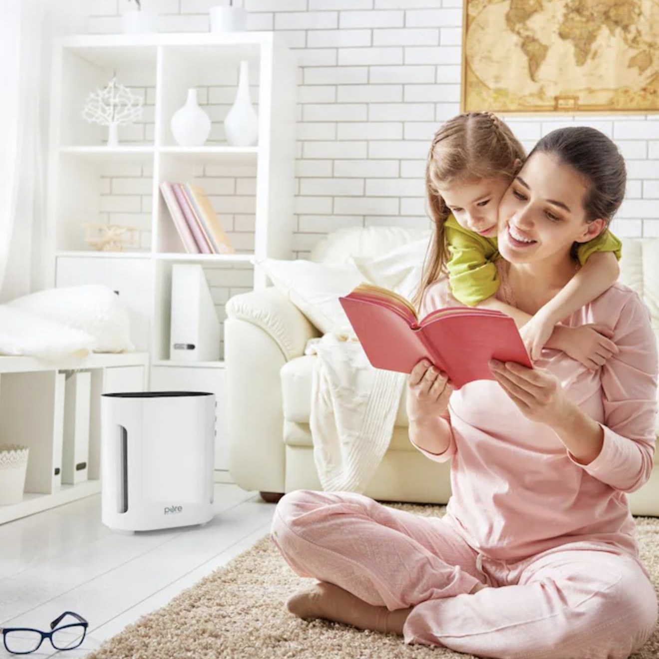 a parent and child reading next to an air purifier