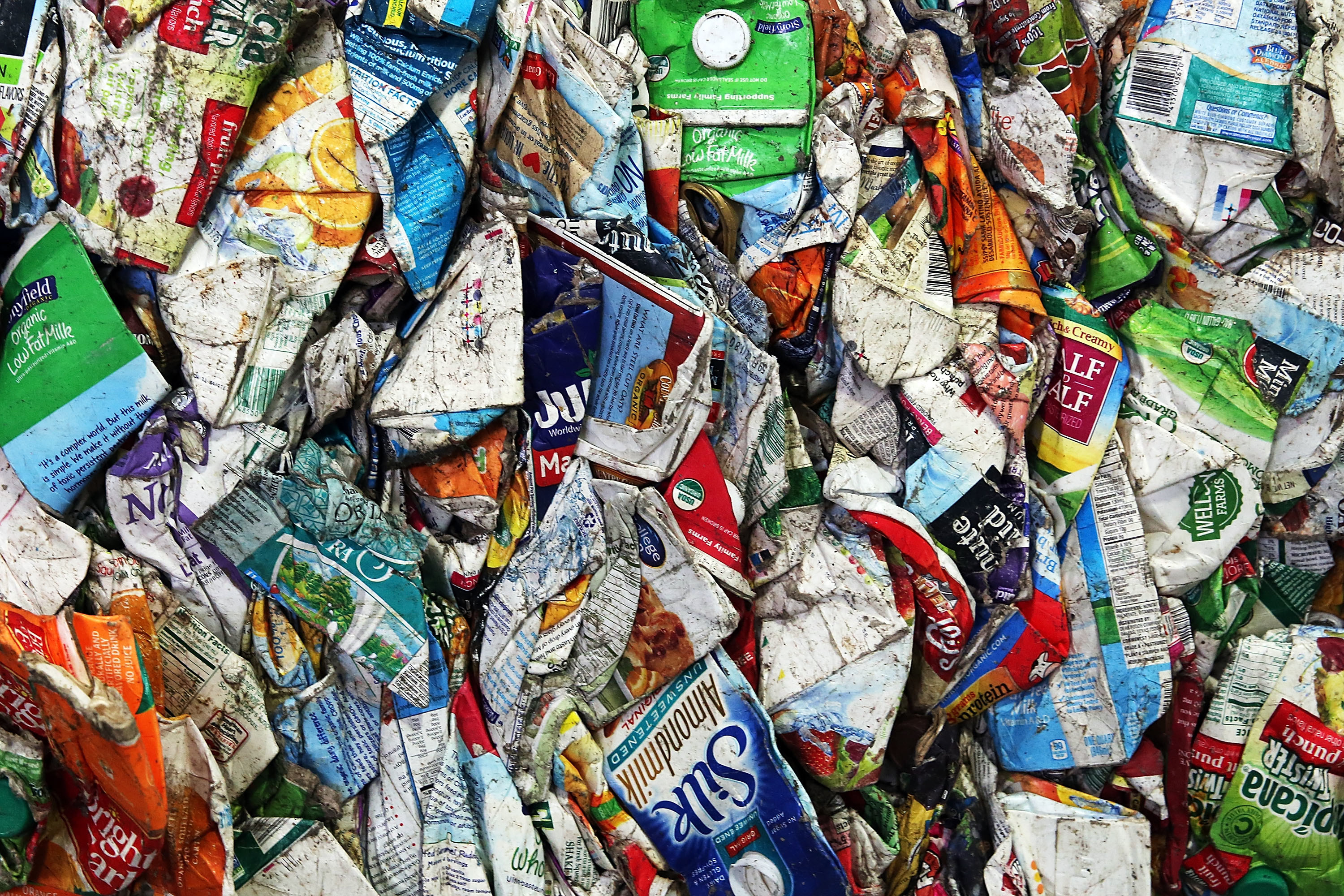 Close up view of milk cartons and recycled containers in a New York facility.