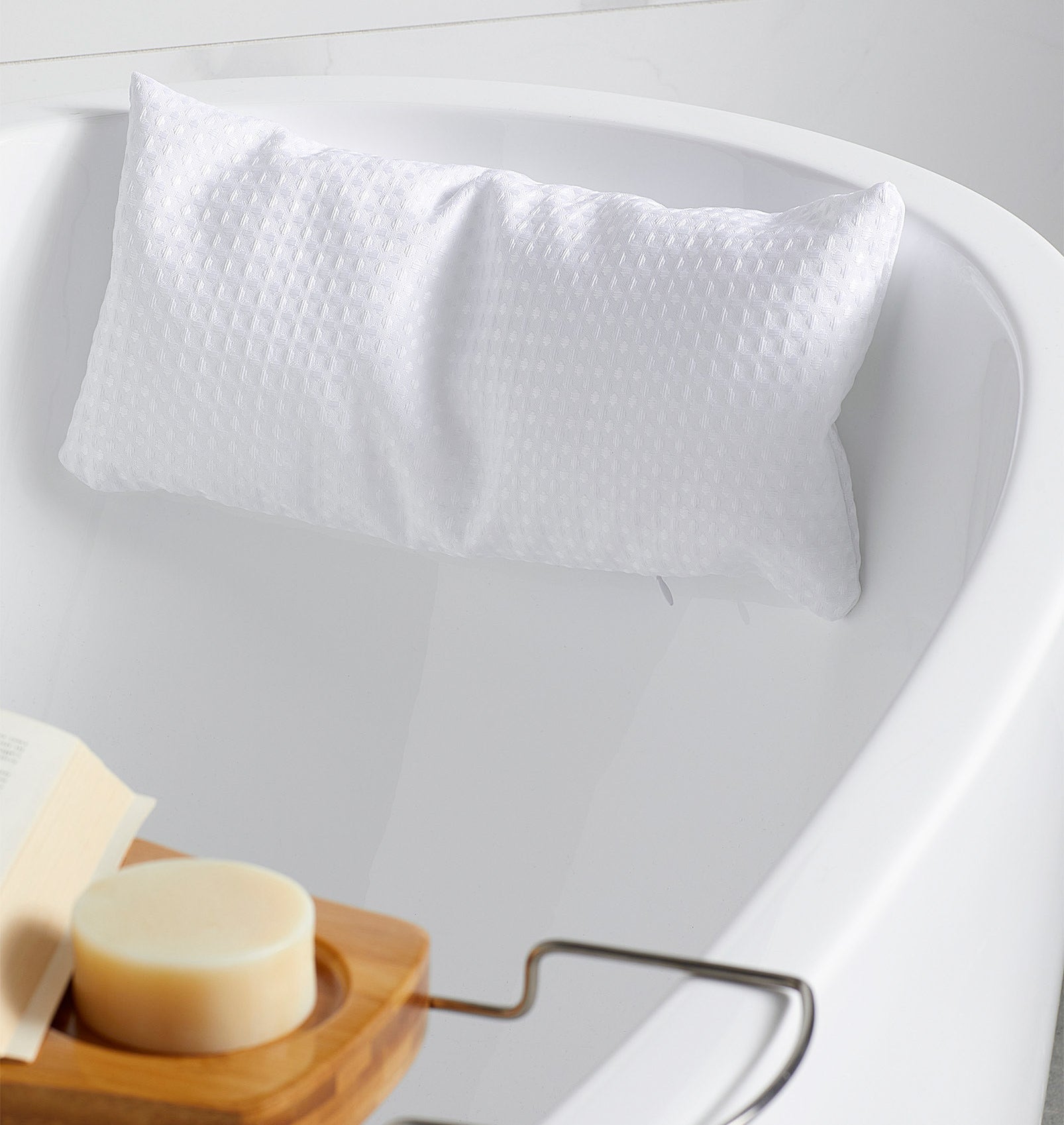 a squishy bath pillow attached to the side of a tub