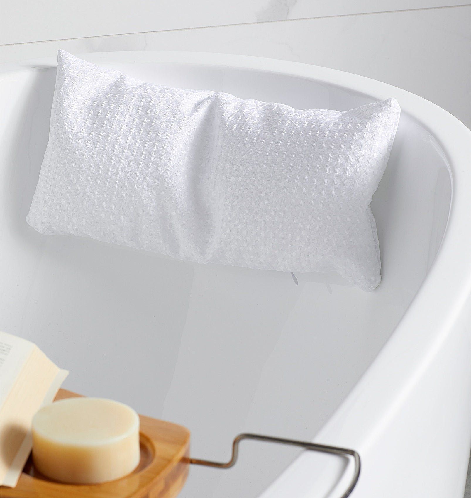 a squishy bath pillow attached to the side of a tub