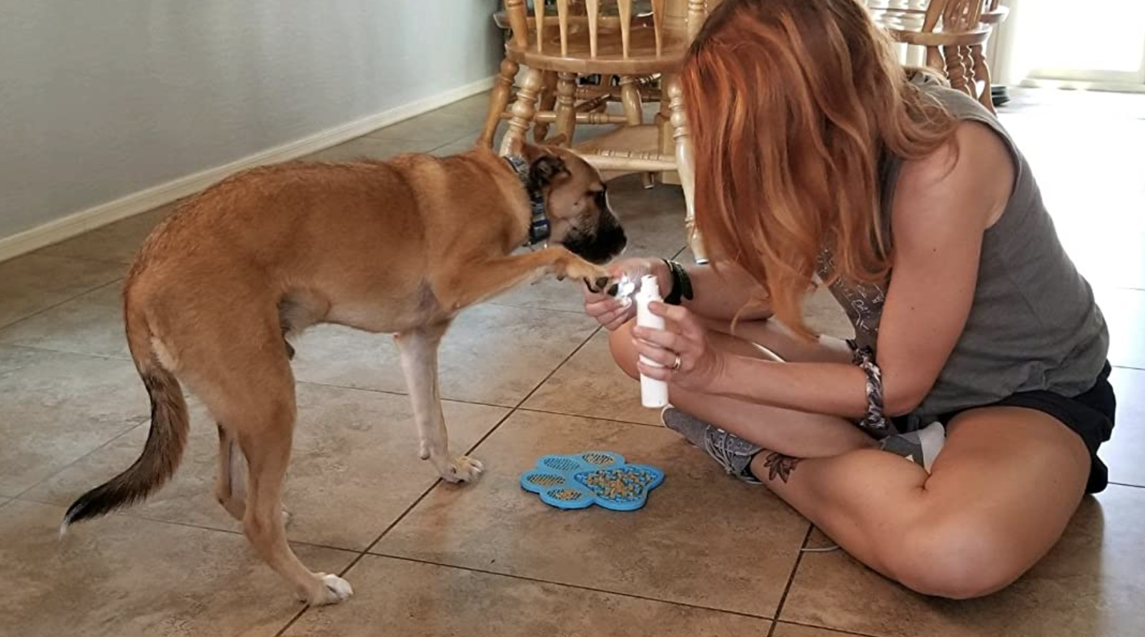 A customer review photo of them giving their dog a manicure