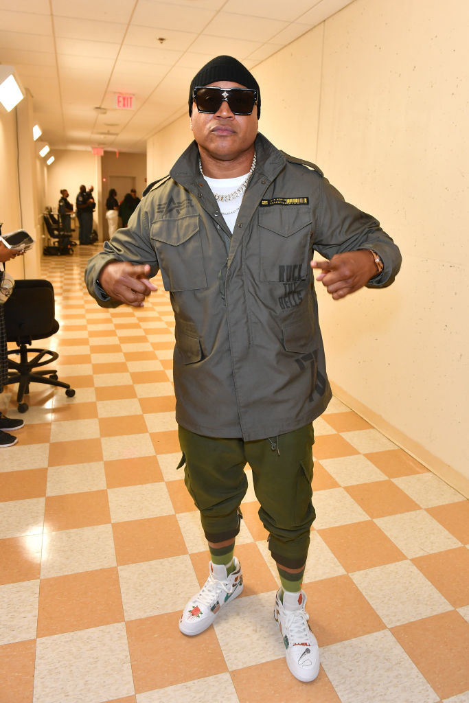 LL Cool J standing in a hallway with sunglasses on