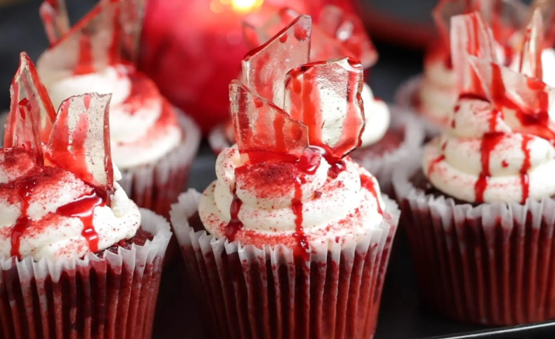 red velvet cupcakes decorated to look like they have blood and glass on top