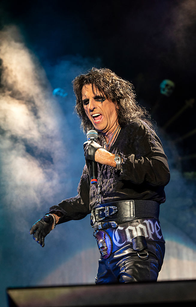 Alice Cooper singing into a microphone