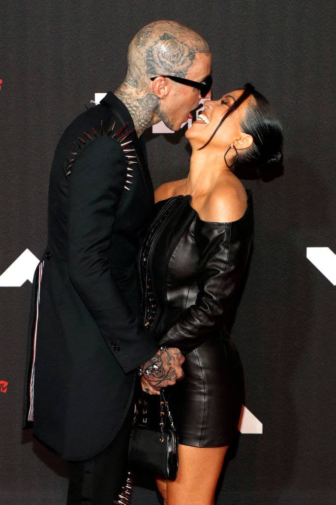 The couple being playful at a red carpet event
