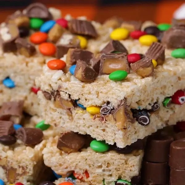 stacked candy topped and filled rice crispy treats