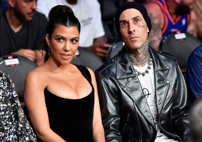Kourtney and Travis sitting front row at an event