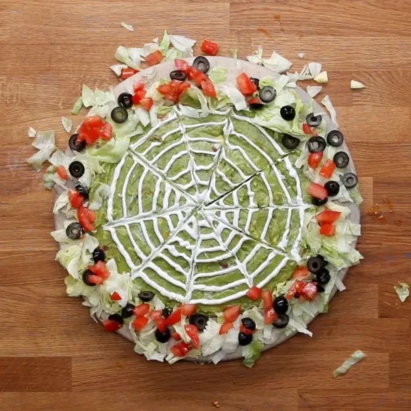 guacamole dip made to resemble a spider web
