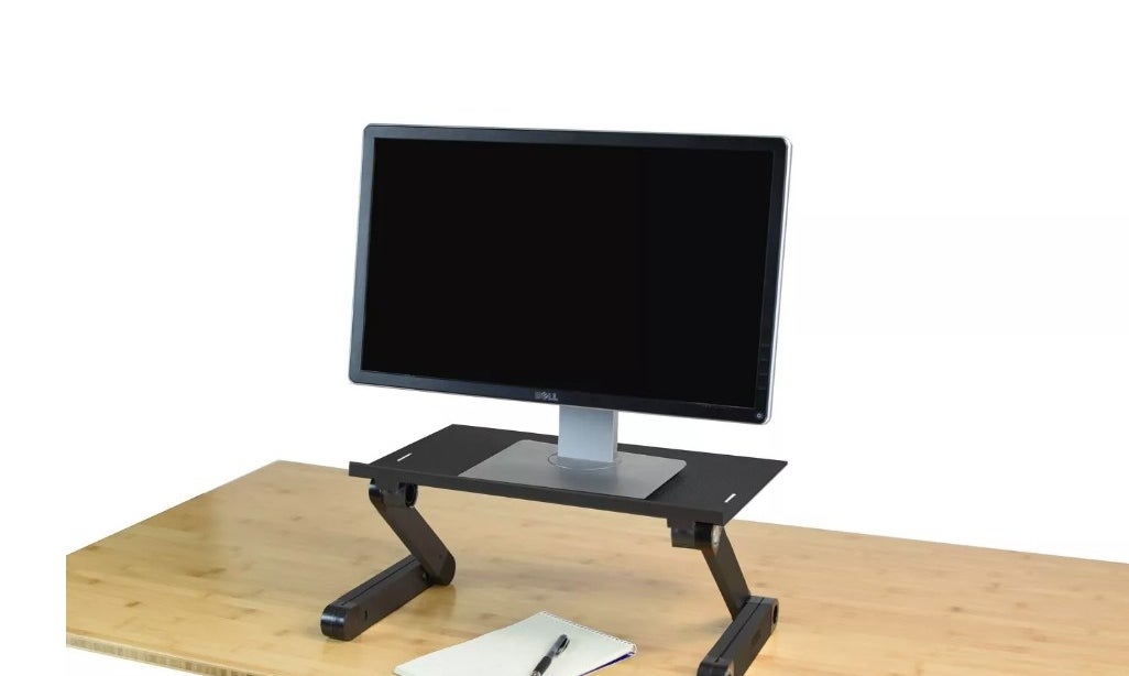 Desktop computer on black desk converter sitting on wooden desk