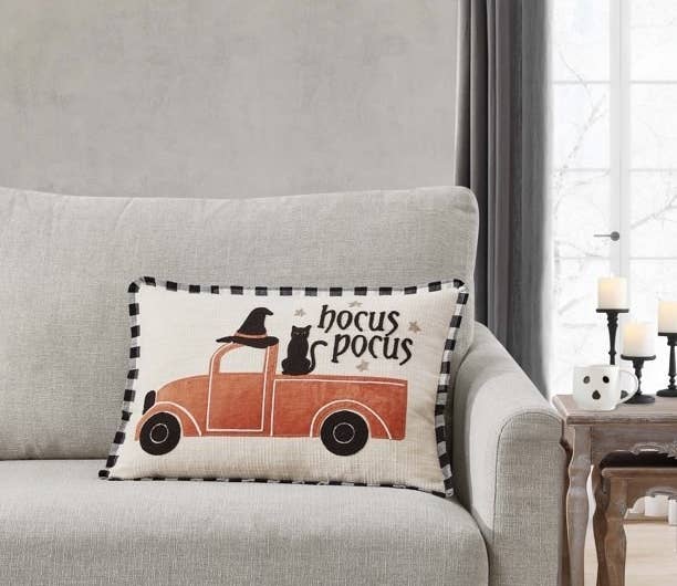 Pillow with the words &quot;hocus Pocus&quot; an orange pickup truck, a black cat, and a witch hat