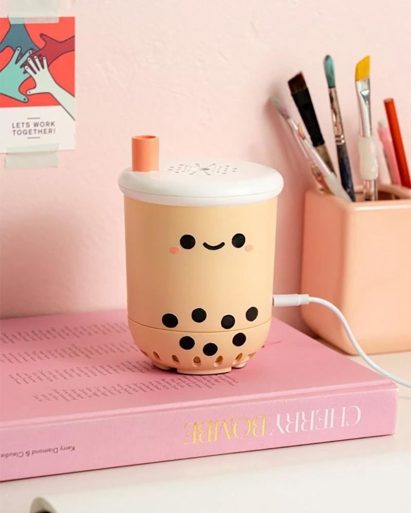 A tiny air purifier in the shape of a cup of bubble tea