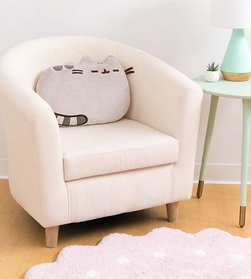 A cat shaped pillow on a chair