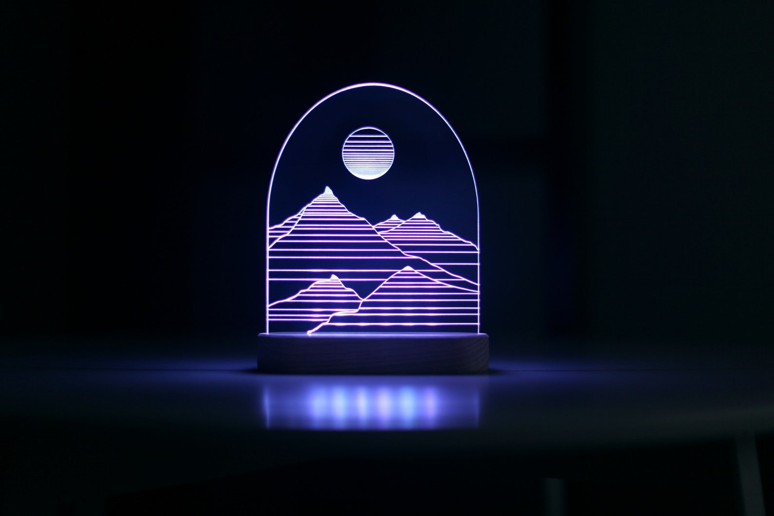 the lamp displaying mountains and the moon in purple