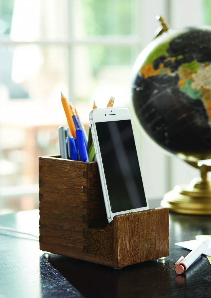 Wooden pencil cup with phone on phone stand