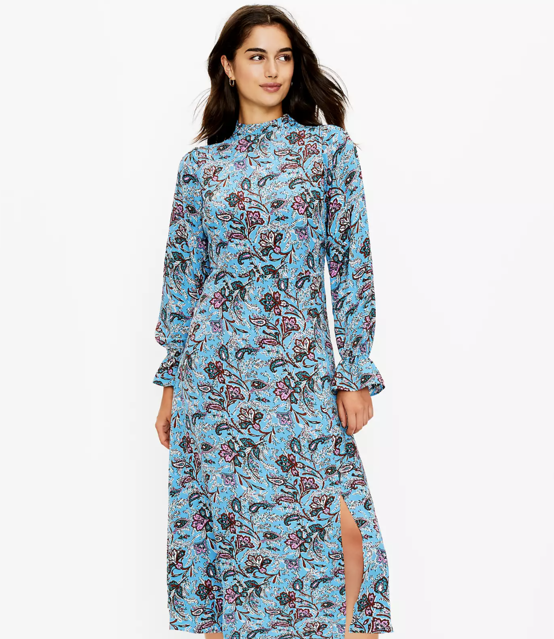 model in blue floral high neck long sleeve dress with a leg slit