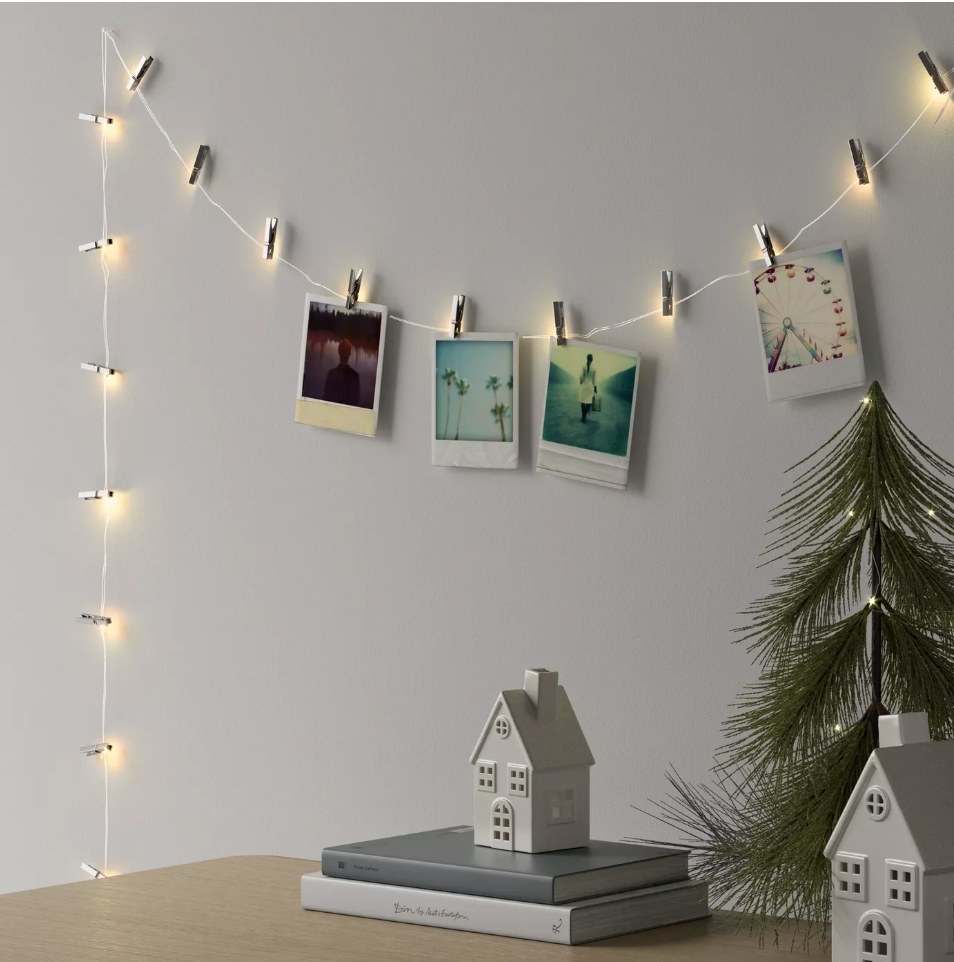 String lights with polaroid pictures hanging from it