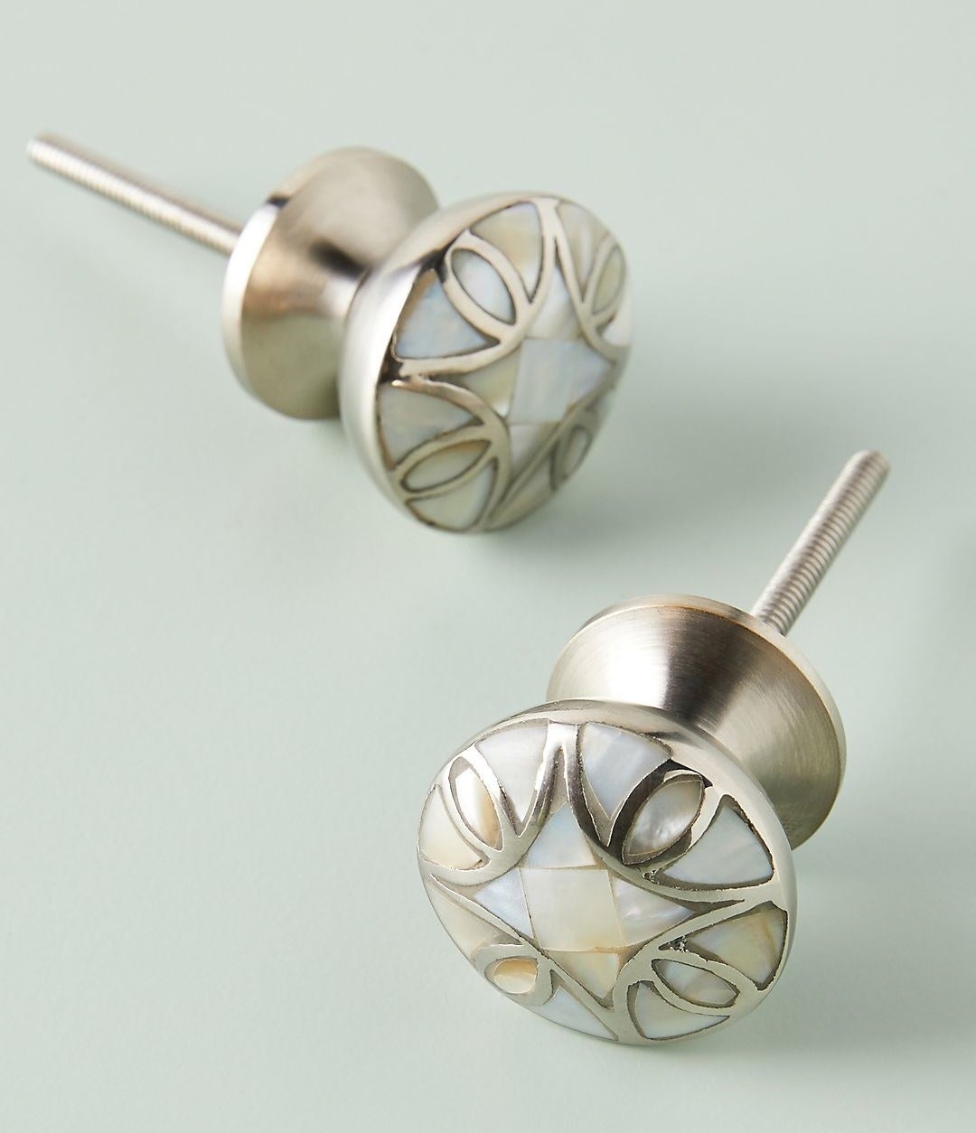 the silver-looking knobs with a mother of pearl design