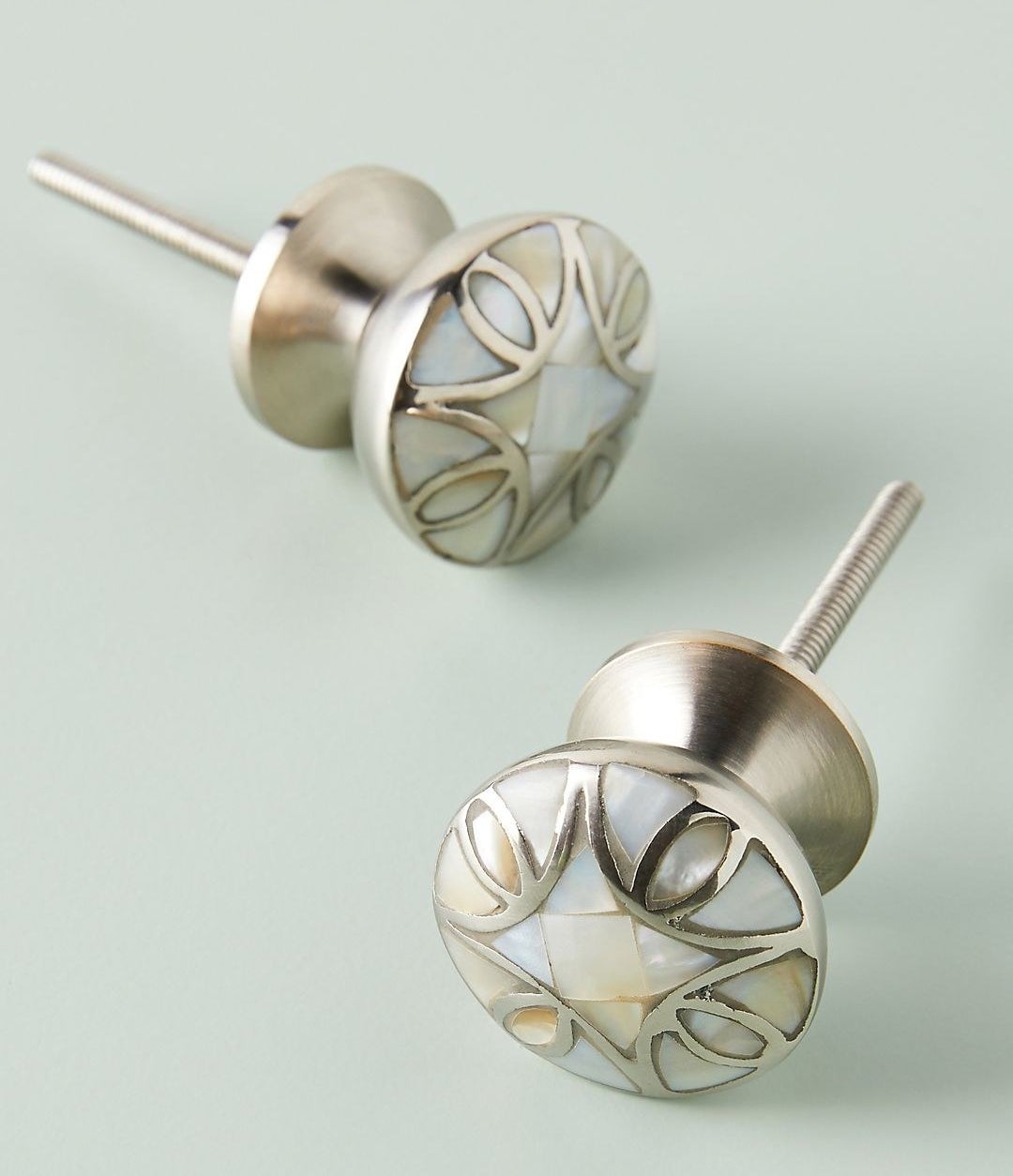 the silver-looking knobs with a mother of pearl design