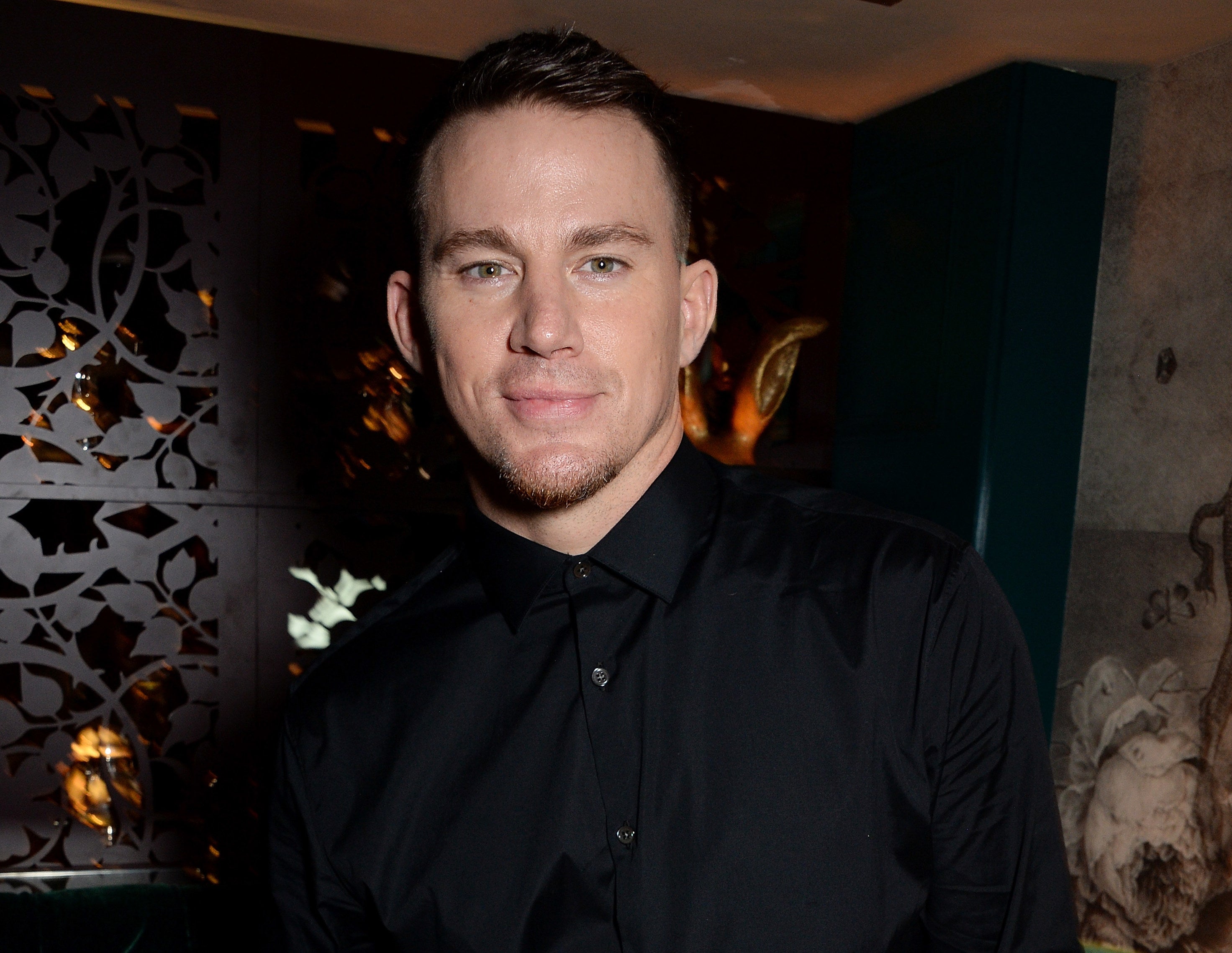 Channing attends and event in a black suit