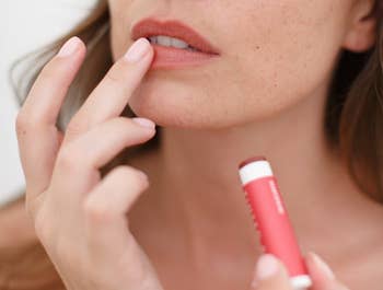model applying the lip balm