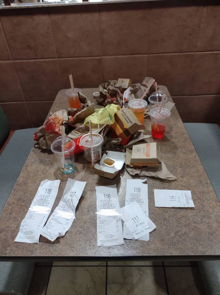 McDonald&#x27;s food wrappers, drinks, and boxes left as garbage on a table