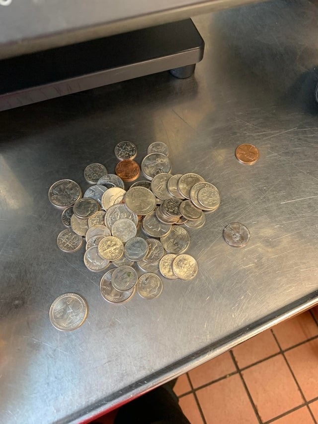 A bunch of loose change dumped on a counter