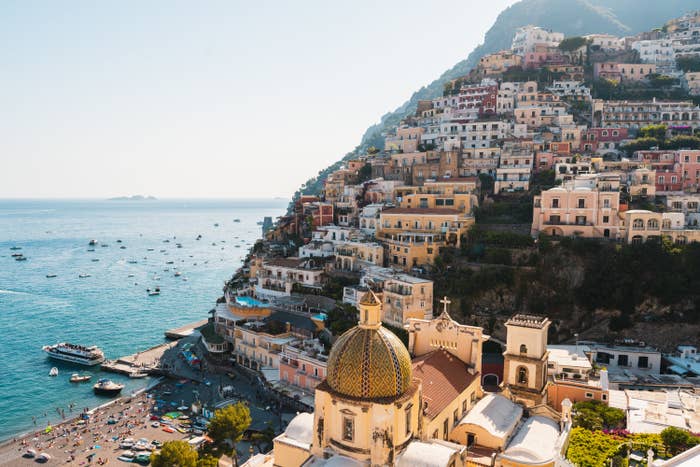 Positano&#x27;s colourful cityscape with leisure and fishing boats on the sea