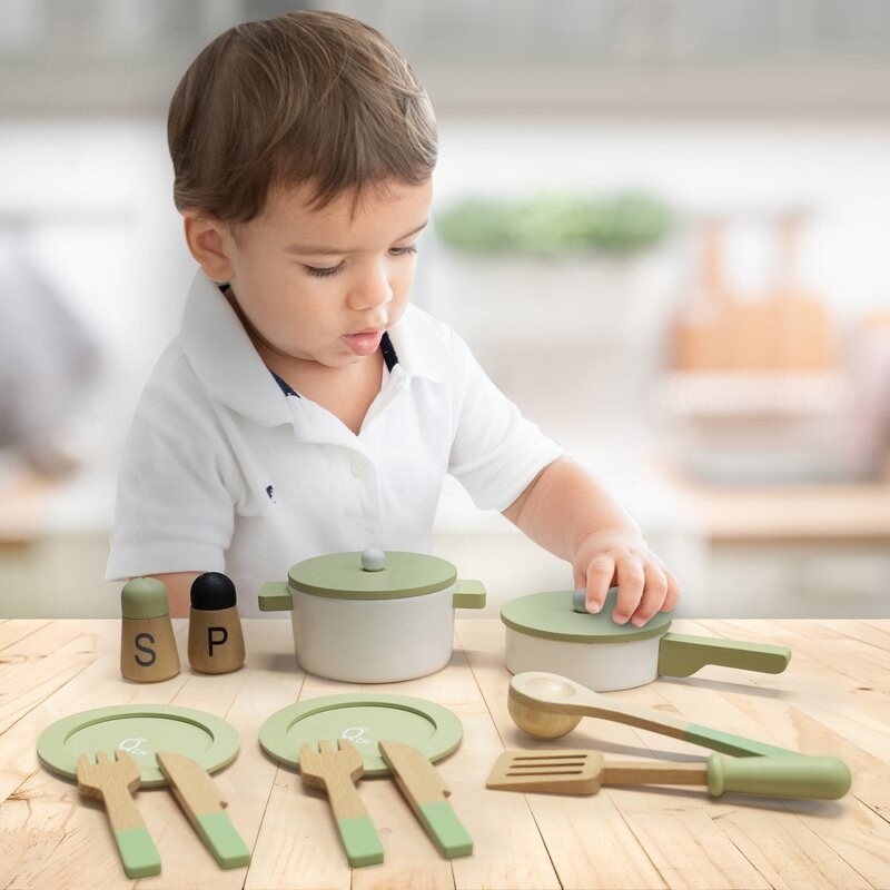 Kid playing with kitchen accessories