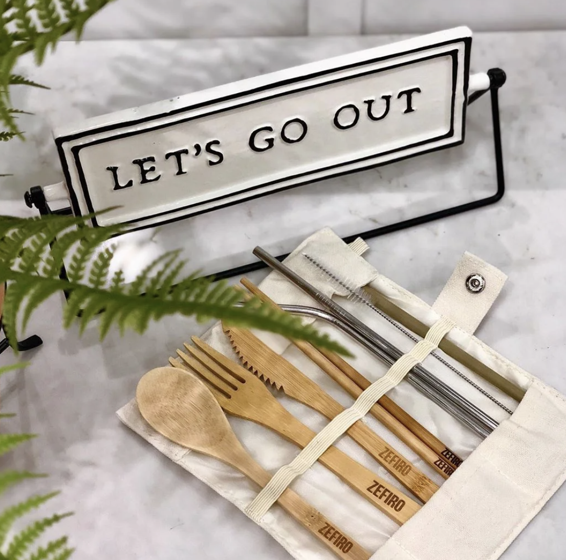 Bamboo spoon, fork, knife, chopsticks, metal straws and straw cleaners in a cloth carrying case.