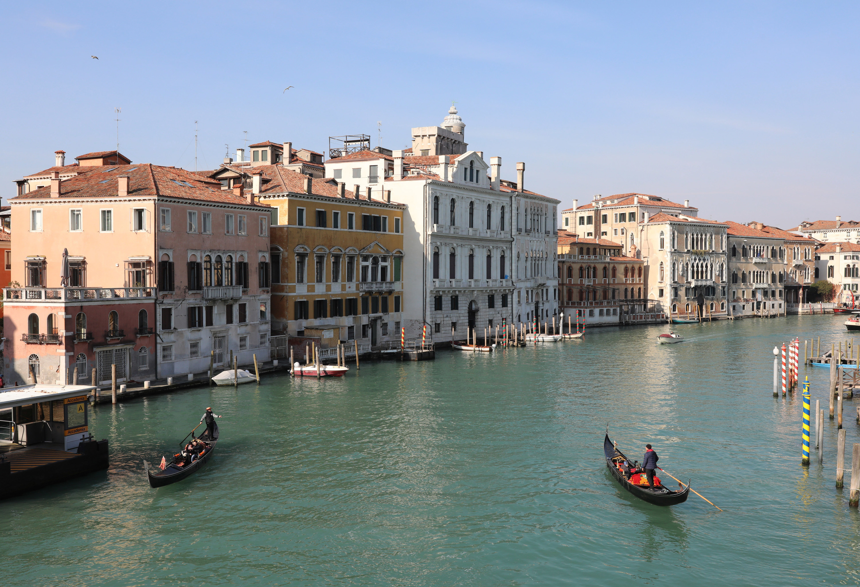Canal in Venice with gondola boats and buildings on the water.
